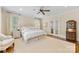 Inviting main bedroom with a plush bed, windows for natural light, and beautiful hardwood flooring at 1728 Shadow Forest Dr, Matthews, NC 28105