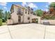 The rear of the house features a porte cochere, stucco siding, a basketball court, and an expansive driveway at 1728 Shadow Forest Dr, Matthews, NC 28105