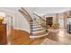 Staircase featuring hardwood steps and wrought iron railing leading to the second floor at 1728 Shadow Forest Dr, Matthews, NC 28105