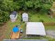 Aerial view of property featuring storage buildings, a deck with umbrella, and mature landscaping at 206 Charlotte St, York, SC 29745