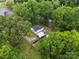 Aerial view of house with mature trees, landscaping, and backyard buildings at 206 Charlotte St, York, SC 29745