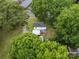 Aerial view of home with a deck, above ground pool, carport, backyard storage buildings, trees, and landscaping at 206 Charlotte St, York, SC 29745