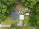Aerial view of home, mature trees, landscaping, rear deck, and backyard storage buildings at 206 Charlotte St, York, SC 29745