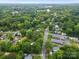 An elevated view of a quiet neighborhood blends residential buildings with lush green trees and a clear sky backdrop at 206 Charlotte St, York, SC 29745