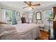 Light-filled bedroom with hardwood floors, dual windows, and a ceiling fan at 206 Charlotte St, York, SC 29745