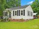 Beautiful home with well-manicured lawn, black shutters, and a charming entrance, perfect for comfortable living at 206 Charlotte St, York, SC 29745