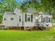Attractive house with vinyl siding, black shutters, and a lush green lawn, creating a welcoming atmosphere at 206 Charlotte St, York, SC 29745