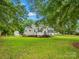 Charming home featuring a well-maintained lawn, mature trees, and a classic exterior design at 206 Charlotte St, York, SC 29745