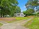 Cozy house with a spacious yard and mature trees, providing a serene and private setting for outdoor enjoyment at 206 Charlotte St, York, SC 29745