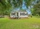 Quaint home with a well-kept lawn and mature trees, offering a serene and inviting curb appeal at 206 Charlotte St, York, SC 29745