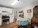 Quaint eat-in kitchen with stainless steel appliances, tile backsplash, and charming decor at 206 Charlotte St, York, SC 29745