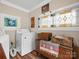 Laundry area features vintage decor, stained glass, washer, and dryer at 206 Charlotte St, York, SC 29745