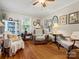 Cozy living room with hardwood floors, a ceiling fan, and lots of natural light at 206 Charlotte St, York, SC 29745