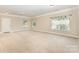 Expansive finished basement with neutral carpet, ample lighting, and access to the outdoors at 237 Lylic Woods Dr, Fort Mill, SC 29715