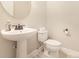 Clean, simple half-bathroom with toilet, modern sink and a decorative mirror at 237 Lylic Woods Dr, Fort Mill, SC 29715