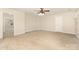 Large bedroom with neutral carpet and paint features ceiling fan and an open door at 237 Lylic Woods Dr, Fort Mill, SC 29715