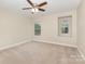 Bright bedroom features a ceiling fan and two windows bringing in natural light at 237 Lylic Woods Dr, Fort Mill, SC 29715