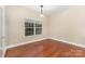 Bright bedroom with hardwood floors, neutral walls, and a large window with sheer curtains at 237 Lylic Woods Dr, Fort Mill, SC 29715