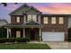 Charming two-story brick home with a manicured front yard and attached two-car garage at 237 Lylic Woods Dr, Fort Mill, SC 29715