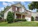 Attractive two-story brick home with covered porch, neat landscaping, and attached two-car garage at 237 Lylic Woods Dr, Fort Mill, SC 29715