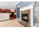 The cozy fireplace features a stone surround and is adjacent to a modern, open kitchen at 237 Lylic Woods Dr, Fort Mill, SC 29715