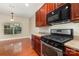 Kitchen featuring stainless steel appliances, wood cabinets, and hardwood floors at 237 Lylic Woods Dr, Fort Mill, SC 29715