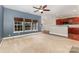 Open-concept living room with a ceiling fan, modern windows and a view of the kitchen at 237 Lylic Woods Dr, Fort Mill, SC 29715