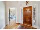 Inviting entryway with hardwood floors, wooden door, and view of a cozy living room at 2616 Carmarthen Ct, Matthews, NC 28104