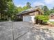 Brick house featuring a two-car garage, a long drive way and manicured landscaping at 2616 Carmarthen Ct, Matthews, NC 28104