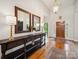 Elegant foyer with hardwood floors, console table, decorative lamps, and grand entry door at 2616 Carmarthen Ct, Matthews, NC 28104