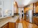 Traditional kitchen with granite countertops, stainless steel appliances, and hardwood floors at 2616 Carmarthen Ct, Matthews, NC 28104