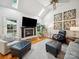 Bright living room featuring a fireplace, hardwood floors, skylights, and comfortable seating at 2616 Carmarthen Ct, Matthews, NC 28104