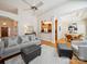 Open-concept living area with hardwood floors, stylish seating, and views into the kitchen and dining room at 2616 Carmarthen Ct, Matthews, NC 28104