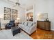 Cozy living room with a comfortable sofa, hardwood floors, and stylish decor at 2616 Carmarthen Ct, Matthews, NC 28104