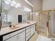 Primary bathroom featuring a dual sink vanity, glass shower, and large mirror at 2616 Carmarthen Ct, Matthews, NC 28104