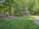 Well-maintained backyard shed with brick exterior and a manicured lawn at 2616 Carmarthen Ct, Matthews, NC 28104