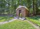 Charming backyard shed with brick exterior and well-manicured landscaping at 2616 Carmarthen Ct, Matthews, NC 28104