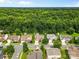 Aerial view showing the home's setting in a wooded neighborhood with manicured lawns and mature trees at 3008 Cornflower Ln, Indian Trail, NC 28079