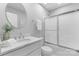 Updated bathroom featuring modern vanity, glass shower doors, and round mirror at 3008 Cornflower Ln, Indian Trail, NC 28079