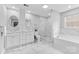 Bright bathroom with dual vanity, marble floors, glass shower, and a soaking tub at 3008 Cornflower Ln, Indian Trail, NC 28079