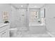 Bright bathroom with a glass-enclosed shower, soaking tub, and modern fixtures at 3008 Cornflower Ln, Indian Trail, NC 28079