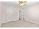 Neutral bedroom featuring carpet, ceiling fan, and doors at 3008 Cornflower Ln, Indian Trail, NC 28079