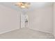 Neutral bedroom with carpet, ceiling fan, and access to other rooms at 3008 Cornflower Ln, Indian Trail, NC 28079