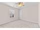 Neutral bedroom featuring carpet, ceiling fan, and natural light at 3008 Cornflower Ln, Indian Trail, NC 28079