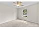 Bedroom with ceiling fan and a window with neighborhood views at 3008 Cornflower Ln, Indian Trail, NC 28079
