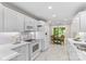 Clean white kitchen featuring stainless steel appliances, marble floors, and ample cabinet space at 3008 Cornflower Ln, Indian Trail, NC 28079