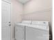 Bright laundry room with washer, dryer, and overhead rack at 3008 Cornflower Ln, Indian Trail, NC 28079