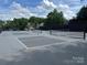 Outdoor pickleball courts surrounded by trees with a fence for a fun and active lifestyle at 3008 Cornflower Ln, Indian Trail, NC 28079