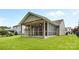 Backyard view of a screened porch with a ceiling fan at 3008 Cornflower Ln, Indian Trail, NC 28079