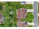 Aerial view of the home with lush landscaping, backyard patio with fire pit and mature trees at 3830 Waters Reach Ln, Indian Trail, NC 28079